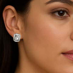 Close-up of a woman wearing a silver earring on her ear.