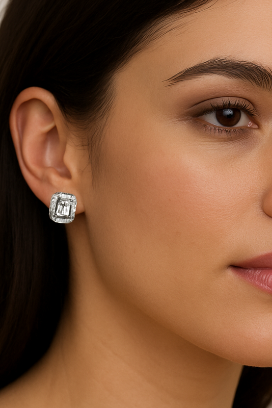 Close-up of a woman wearing a silver earring on her ear.